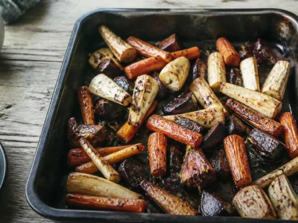 Roasted vegetables spread across a baking tray